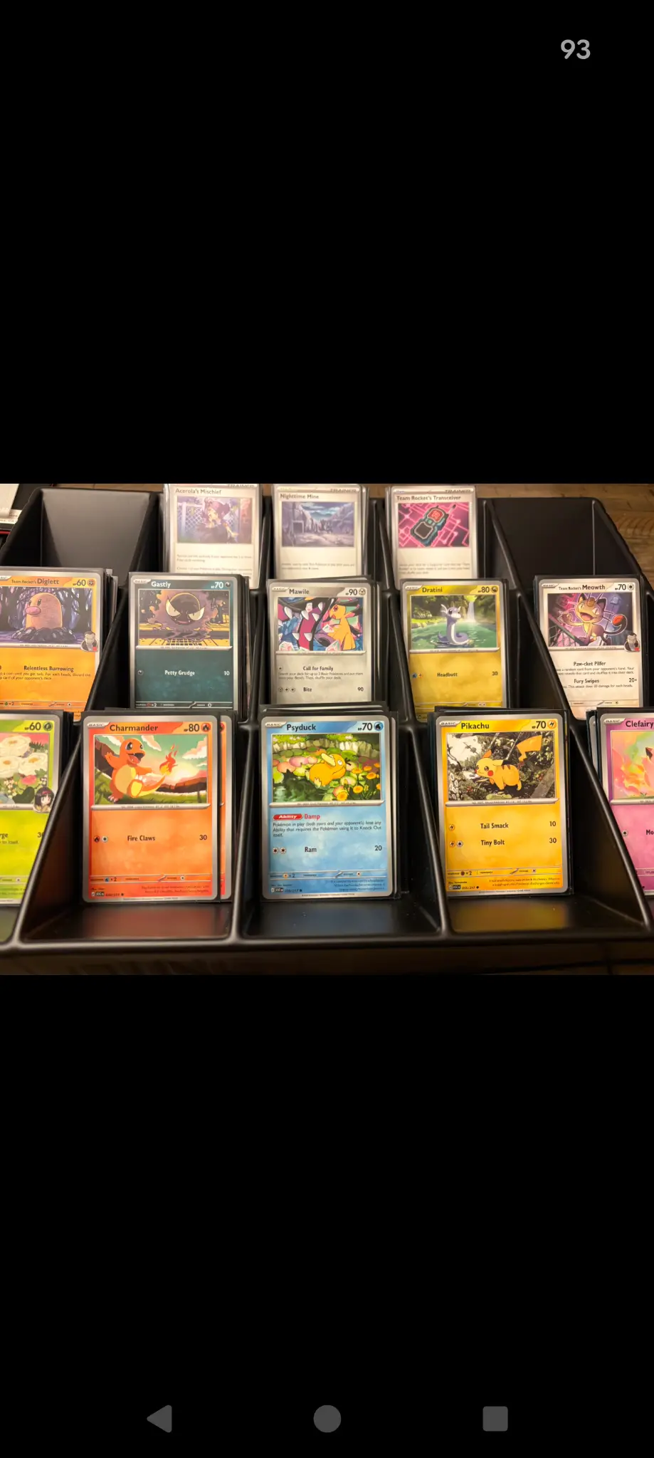 A closer view of Pokémon cards organized in sorting trays